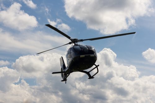 helicopter silhouette in the blue sky