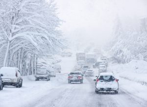 A rural roadway during a snowstorm