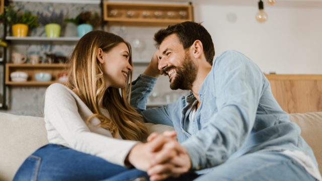 Happy couple talking on couch