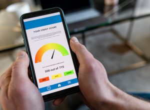 A close up of a smart phone with a person's credit score on it