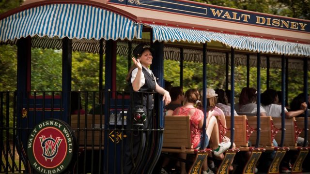 disney cast member waving from tram