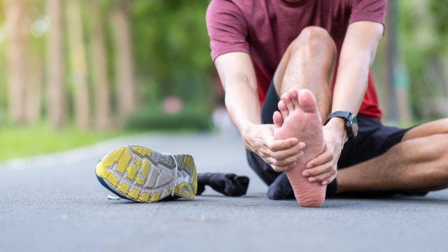 Young adult male with his muscle pain during running