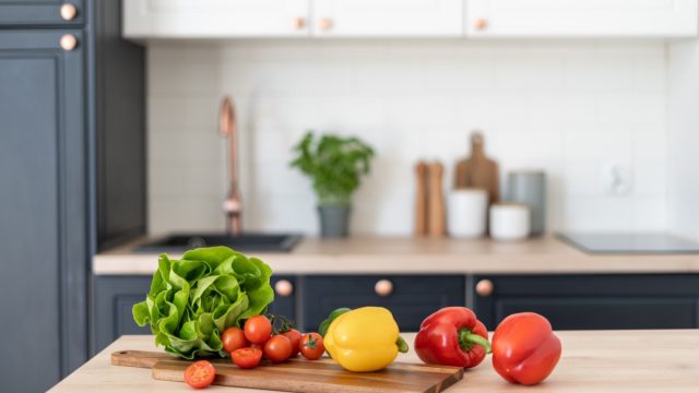 Contemporary kitchen interior design. Healthy food products on table. Salad ingredients. Cooking at home. Home comfort. Healthy nutrition and lifestyle