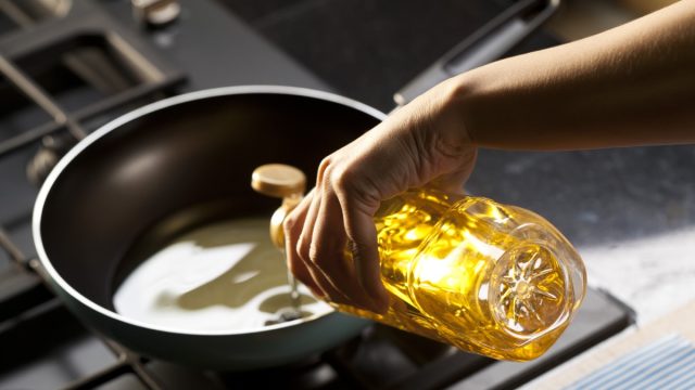 Pouring vegetable oil into frying pan