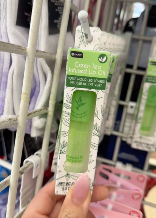 shopper holding lip oil at Dollar Tree