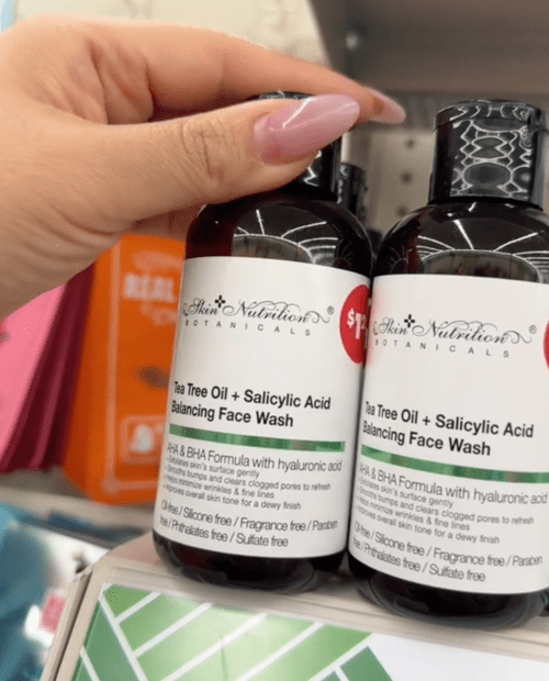 shopper holding facial wash at Dollar Tree