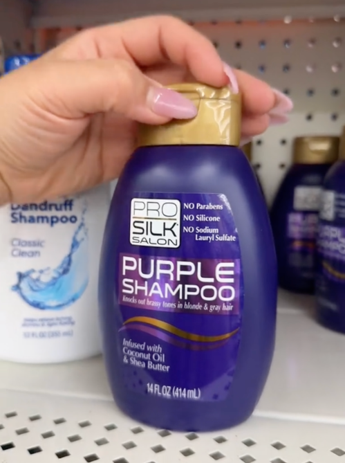 shopper holding purple shampoo at Dollar Tree