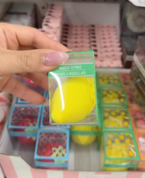 shopper holding lemon-shaped beauty blender at Dollar Tree