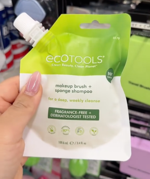 shopper holding cleaning product at Dollar Tree