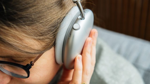 musicophile woman listens to new Apple Computers AirPods Max over-ear headphones with Adaptive EQ, Active Noise Cancellation, Transparency mode h1 chips and Siri