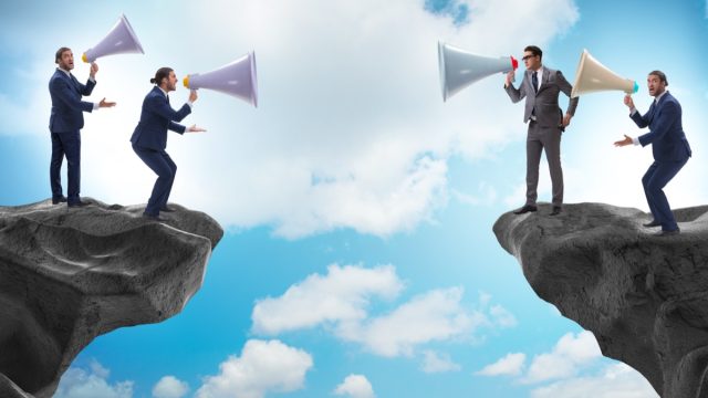 Businessman shouting with loudspeaker at each other