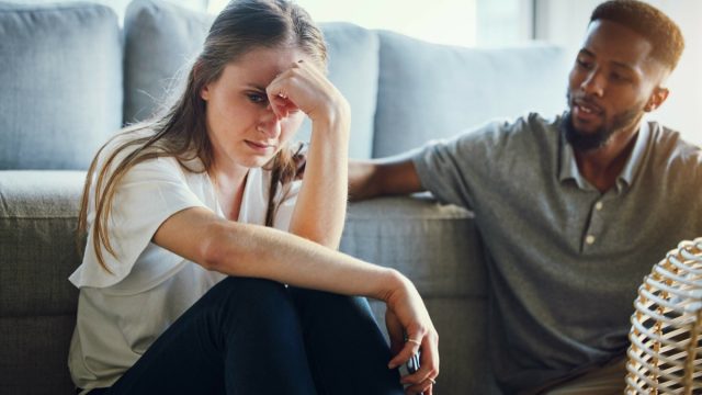 Stress, divorce and couple in living room after a fight, argument or conflict in the marriage at home. Sad, depression or woman with a worried and tired partner cheating thinking of breakup in house