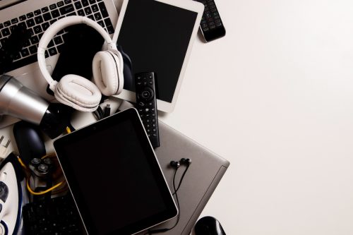 Old computers, digital tablets, mobile phones, many used electronic gadgets devices, broken household and appliances on white background. Planned obsolescence, electronic waste for recycling concept