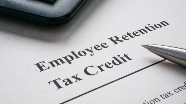 Page with info about employee retention tax credit and pen.