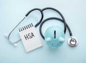 HSA note with a piggy bank and doctor's stethoscope
