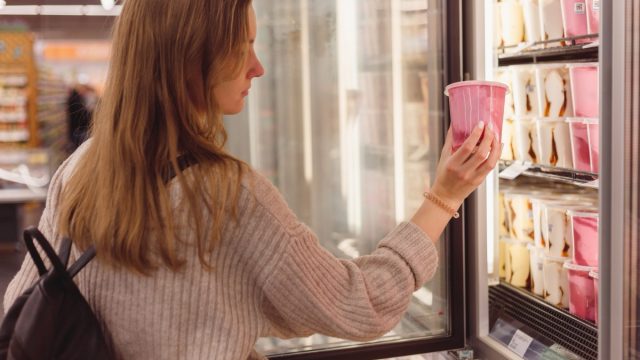 woman buying pint of ice cream