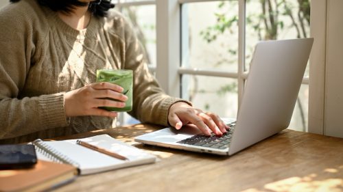 woman drinking matcha tea while working
