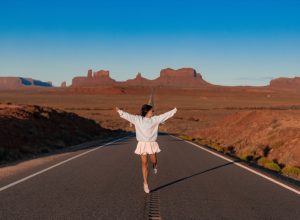young woman posed in front of monument valley