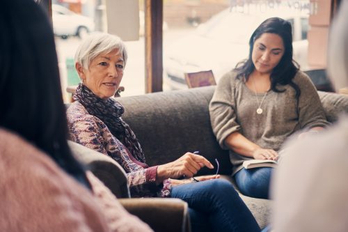 Shot of a group of women attending a book club meeting at a bookstore