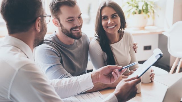 Happy couple meeting with a financial advisor