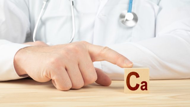 Doctor holding a block that represents calcium