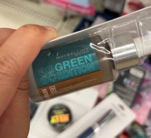 Dollar Tree shopper holding up Maybelline makeup