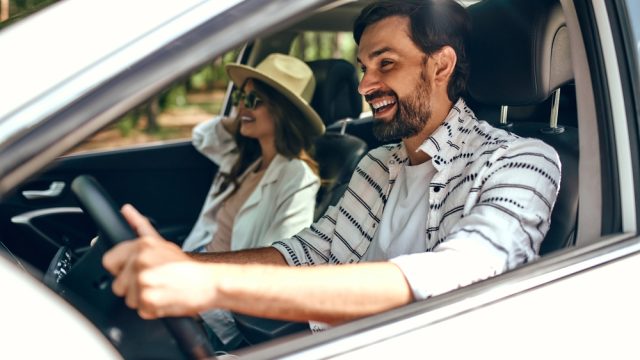 A couple in a car smiling
