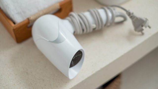 Closeup of a hair dryer on a bathroom counter