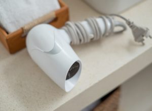 Closeup of a hair dryer on a bathroom counter