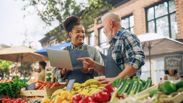 people talking at a farmers market