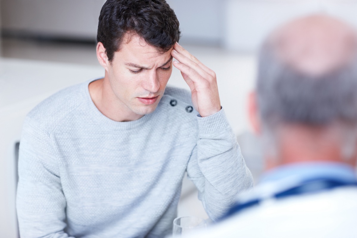 man talking to doctor about headache