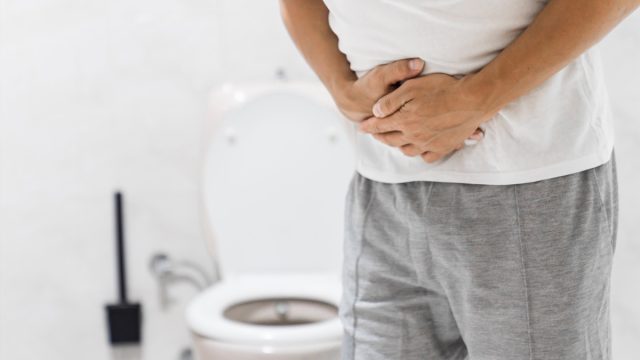 Men have stomachache and use their hands to hold their stomach In the bathroom. Constipation or colon cancer. diarrhea and severely toxic food. Man touch belly in the bathroom. Abdominal pain