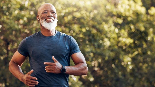 A senior man running in the woods