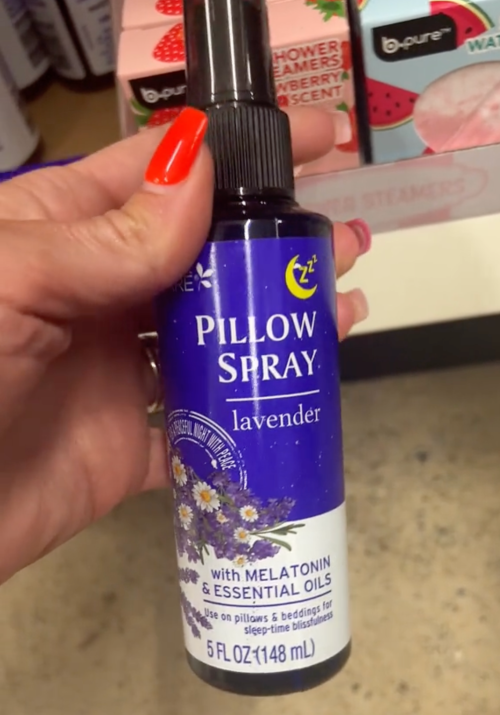 Still from a video of a shopper holding a pillow spray at Dollar Tree
