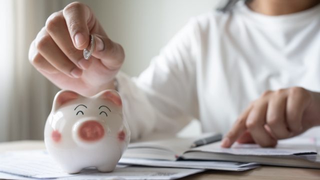 putting coin in piggy bank