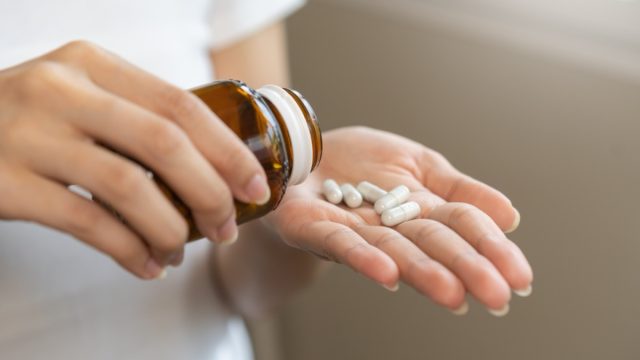 woman taking dietary supplement