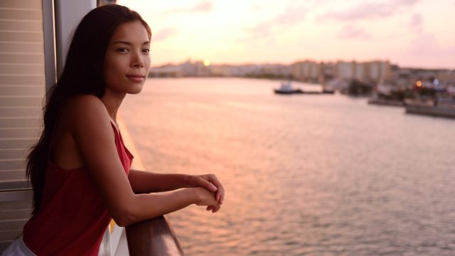 A woman on the balcony of a cruise ship