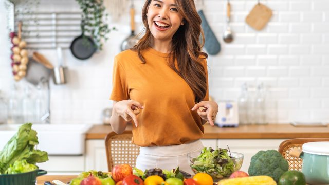 Portrait of beauty body slim healthy asian woman having fun cooking and preparing cooking vegan food healthy eat with fresh vegetable salad on counter in kitchen at home.Diet concept.Fitness, healthy