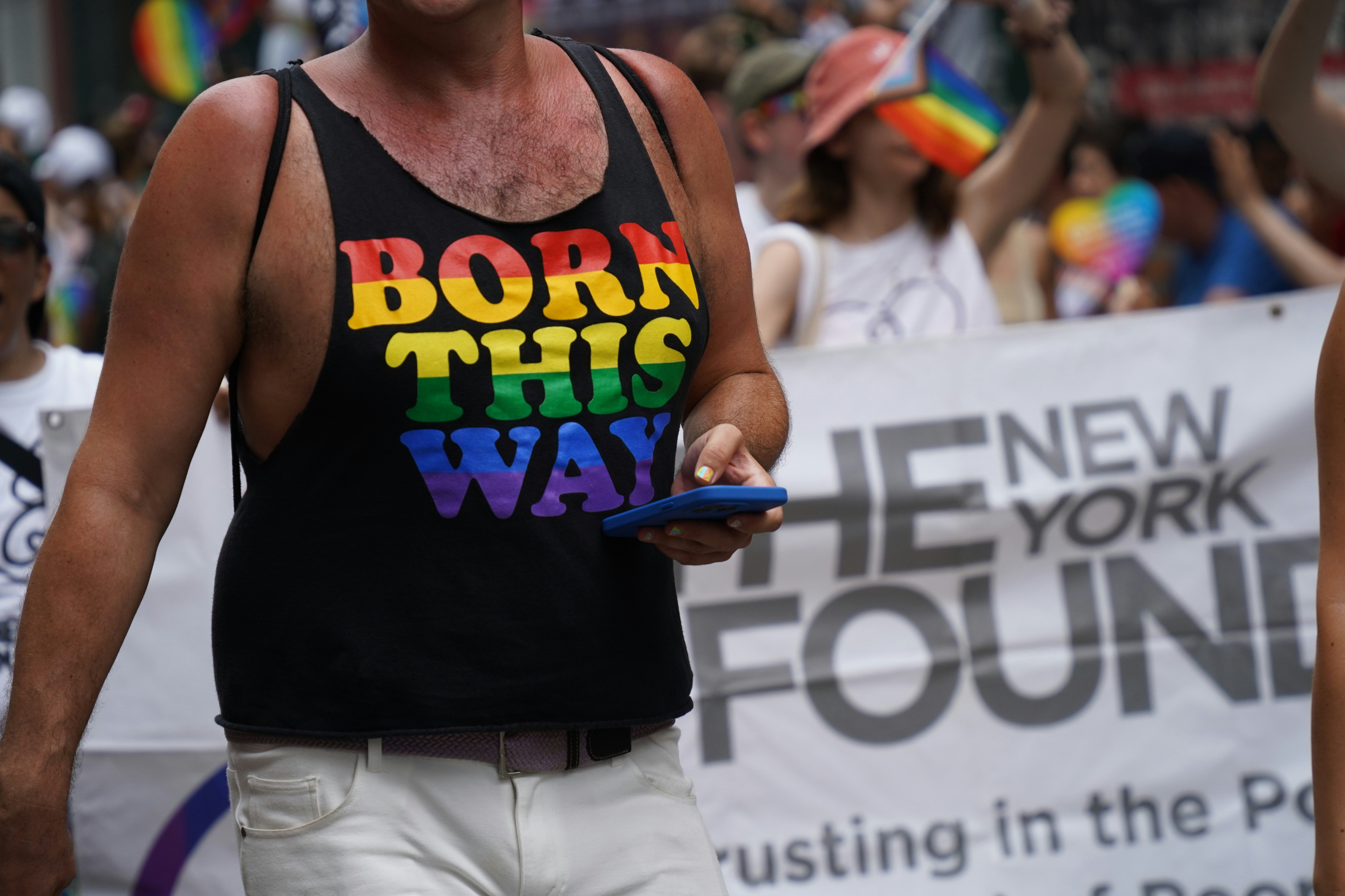 someone wears a Born This Way t-shirt at a rally for LGBTQIA+ rights