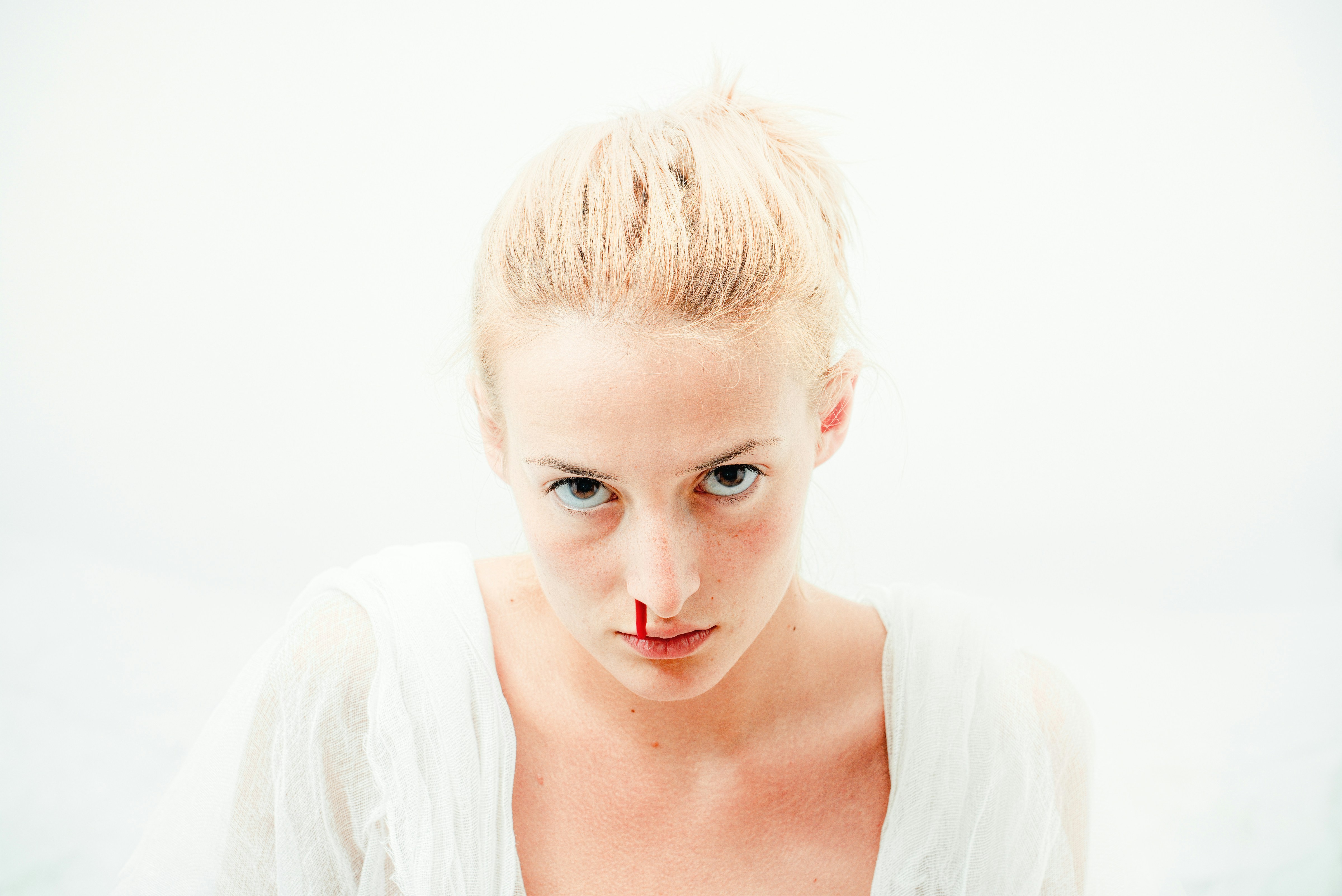 a woman suffers a nose bleed