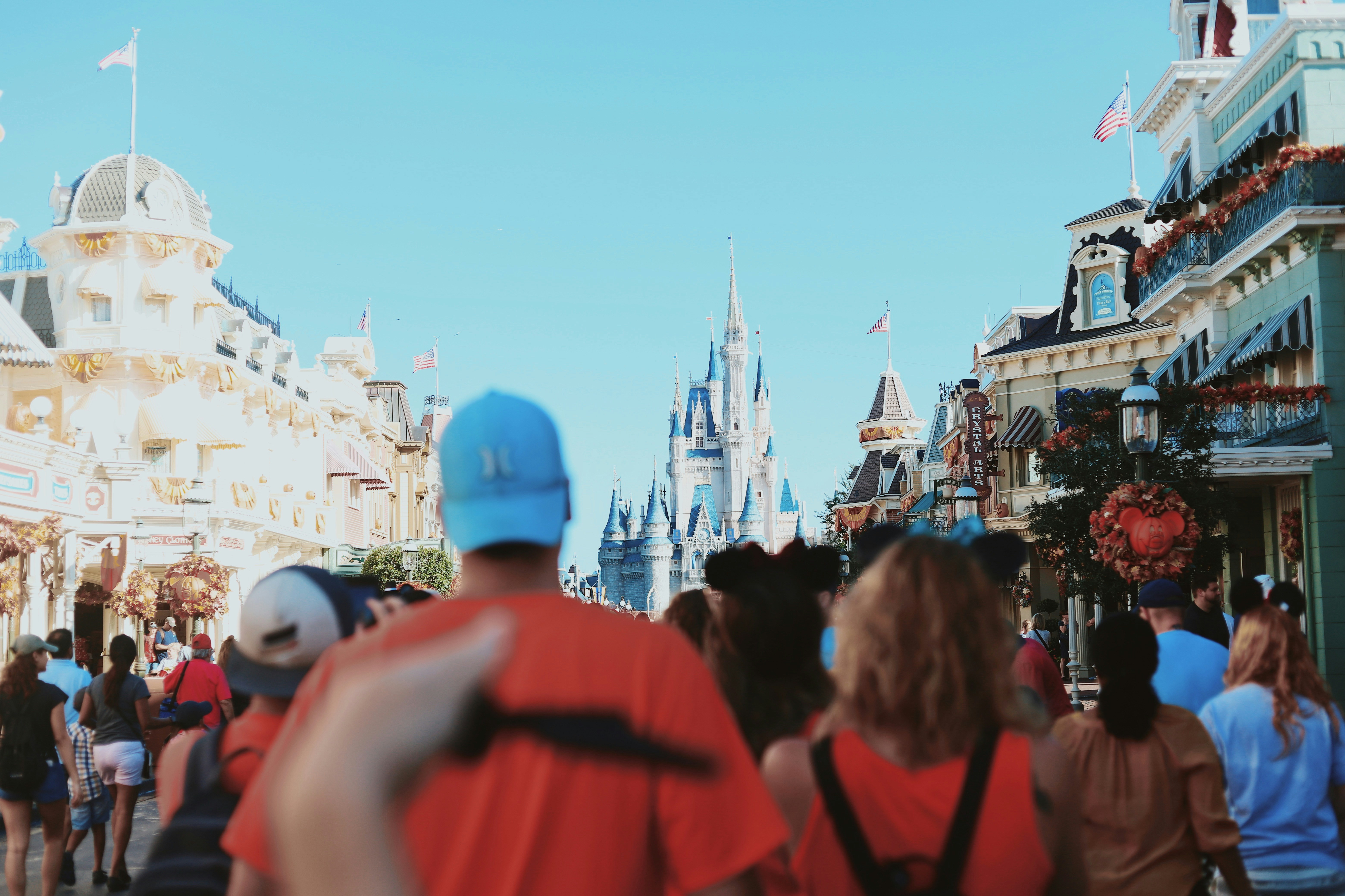 Crowd of people walking through Disney theme park