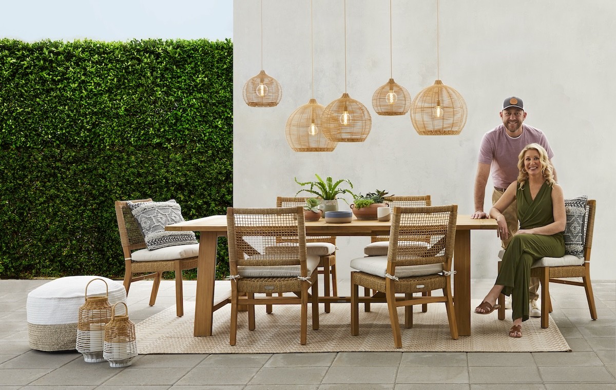 Dave and Jenny Marrs sitting at an outdoor table modeling their furniture collection for Walmart