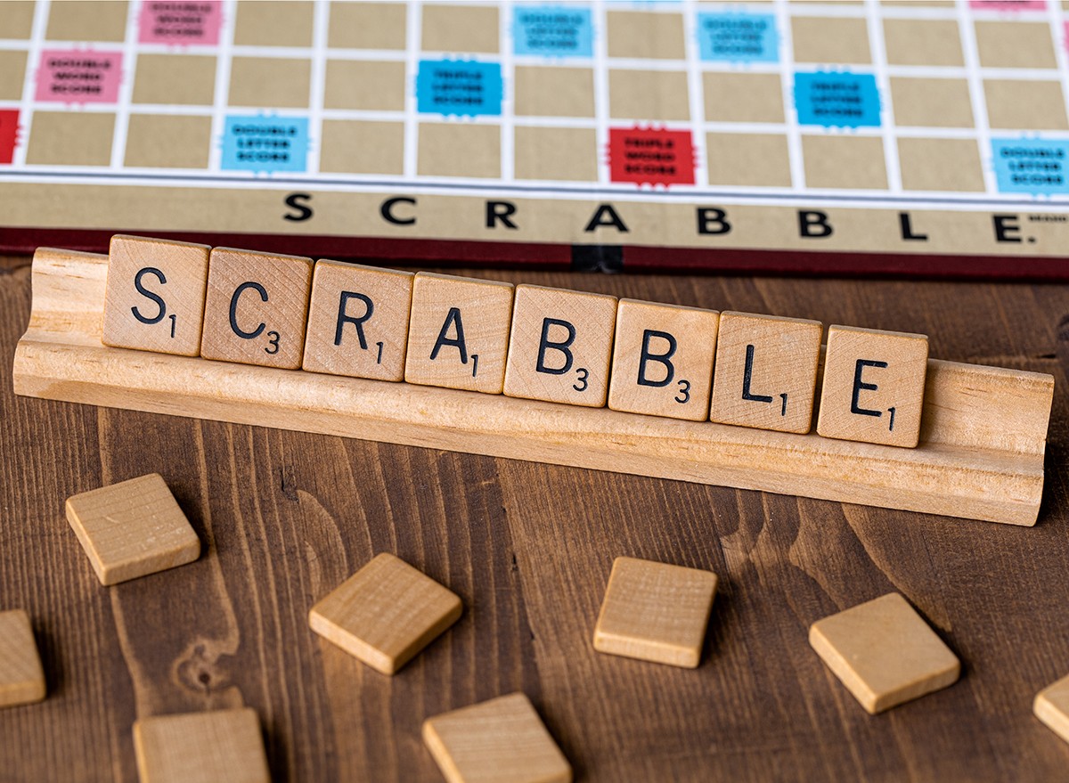 A Scrabble board with pieces on a table
