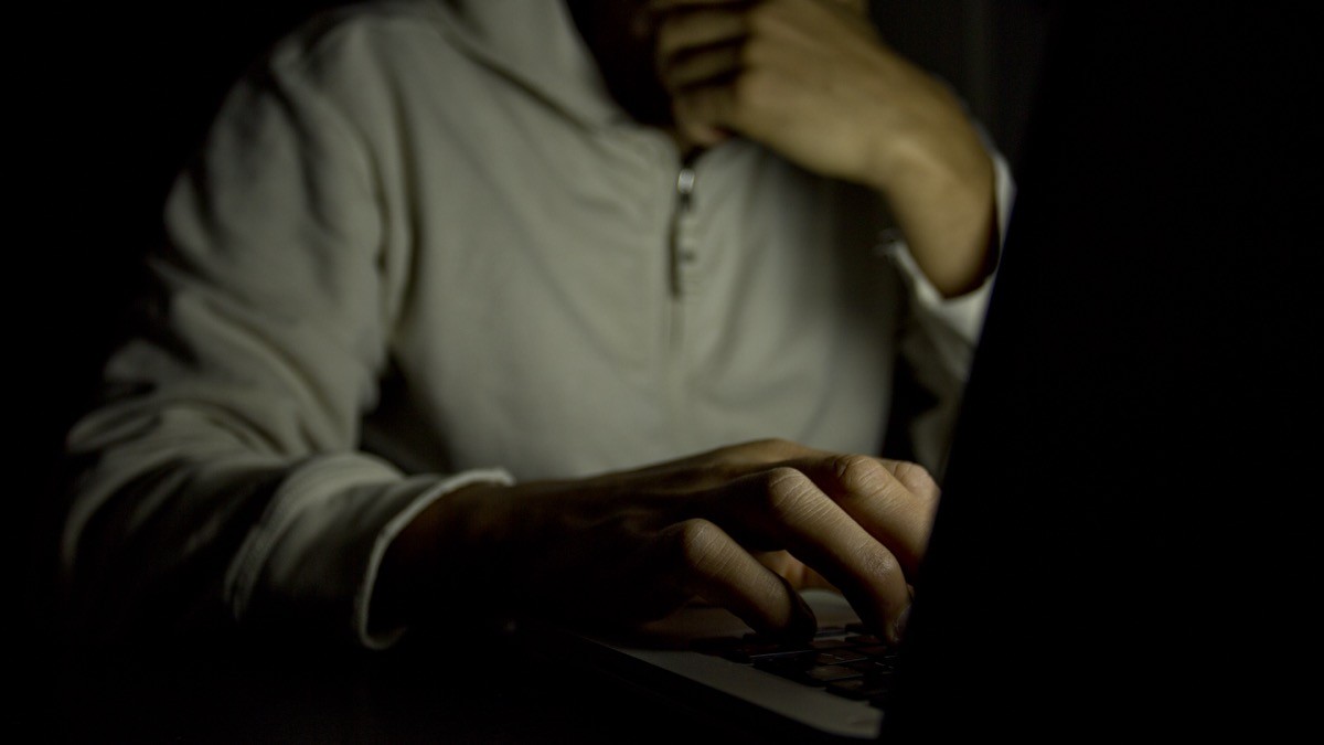 man on his laptop in the dark