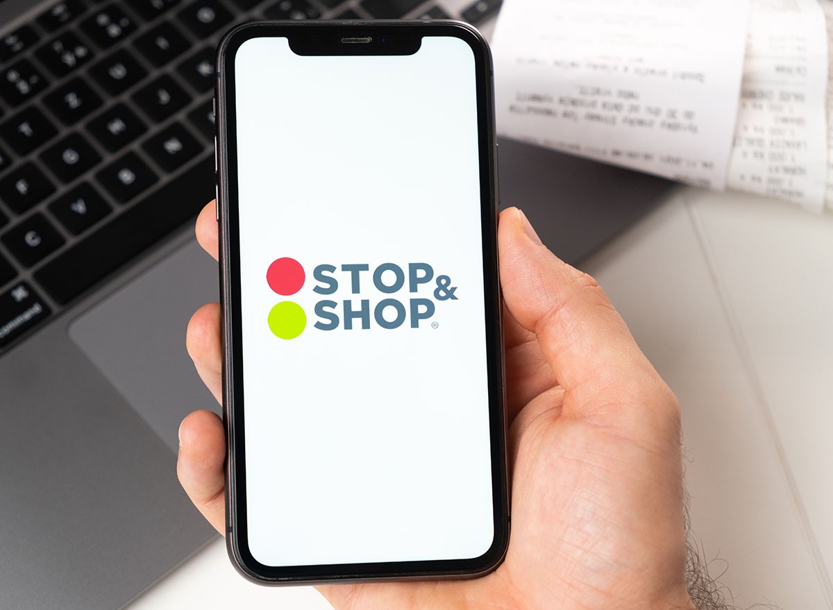 Stop & shop application on the screen of Apple iPhone in mans hand
