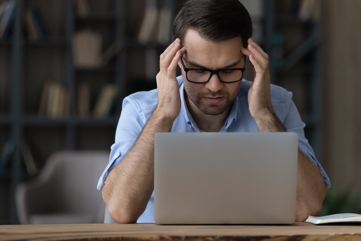 Concerned Man at His Laptop
