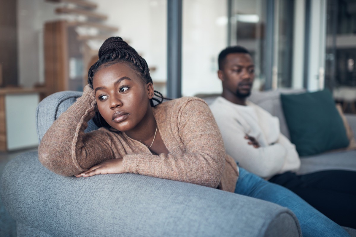 Cropped shot of a young couple sitting on the sofa and giving each other the silent treatment after an argument