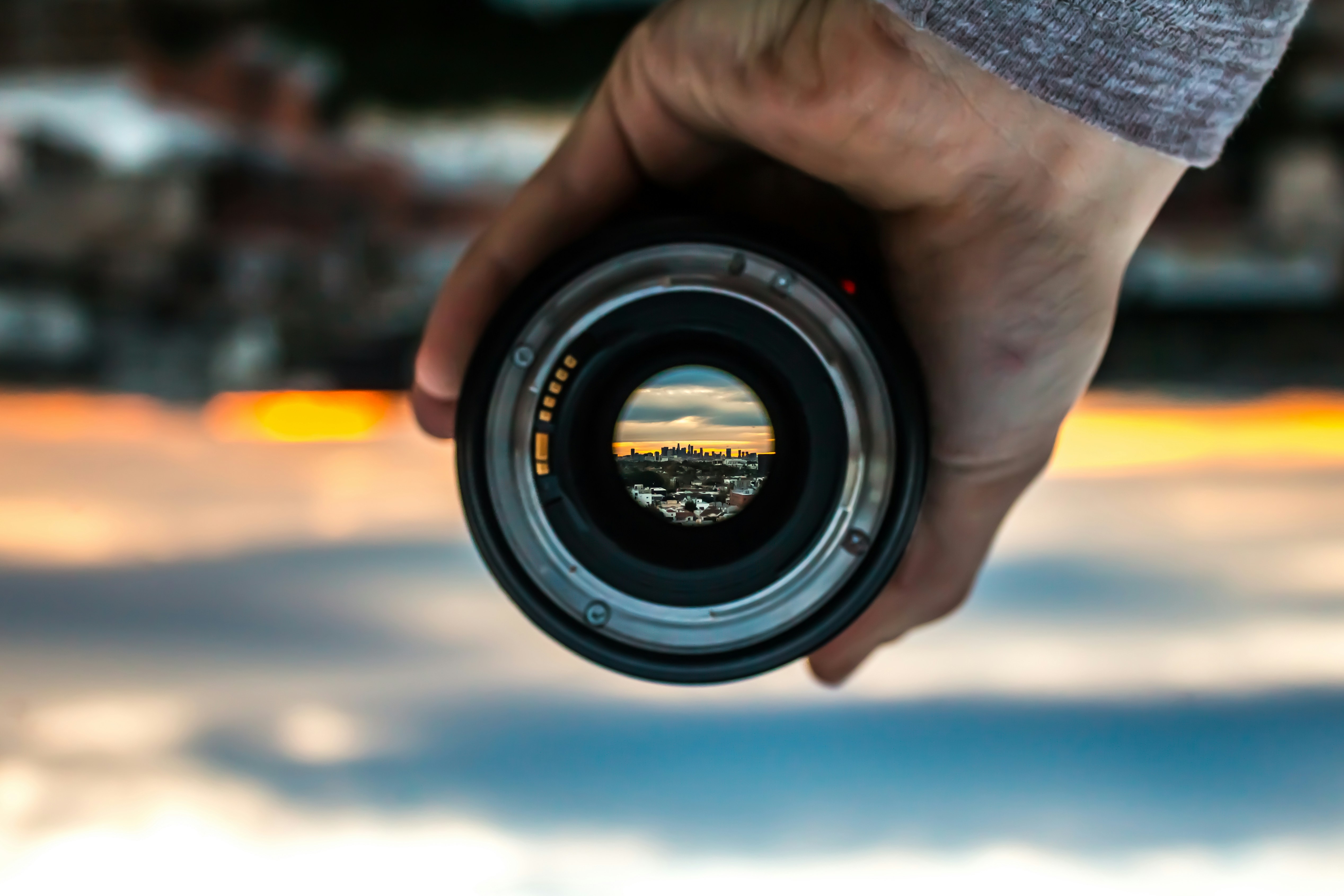 someone holds a lens for greater focus