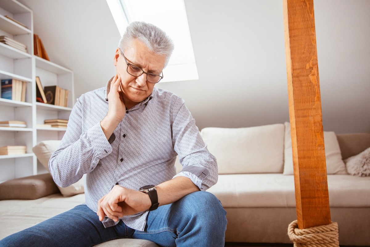mature man checking his resting heart rate