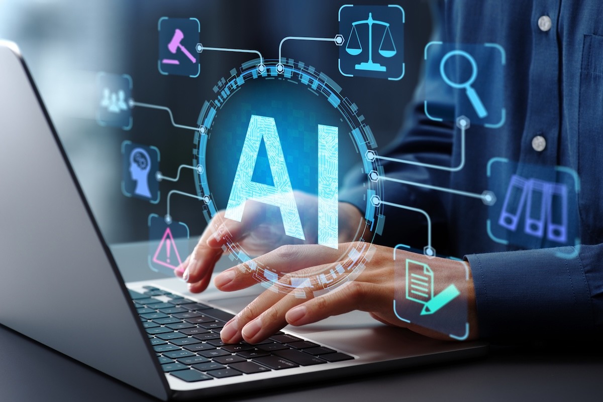 person on a laptop with graphics indicating AI overlaid